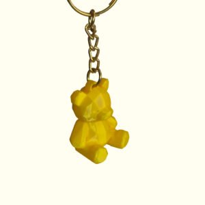 3D printed low poly teddy bear keychain in yellow with faceted geometric design