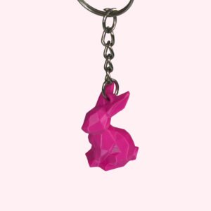 3D printed low poly rabbit keychains in green, orange, magenta and yellow with faceted design