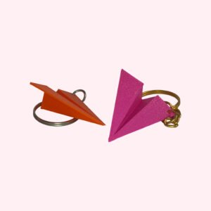 3D printed paper airplane keychains in yellow, orange, green and magenta with silver and gold keyrings
