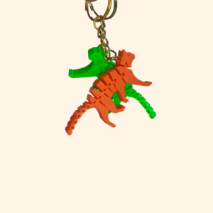 3D printed articulated flexi cat keychains in pink, yellow and green with jointed bendy bodies